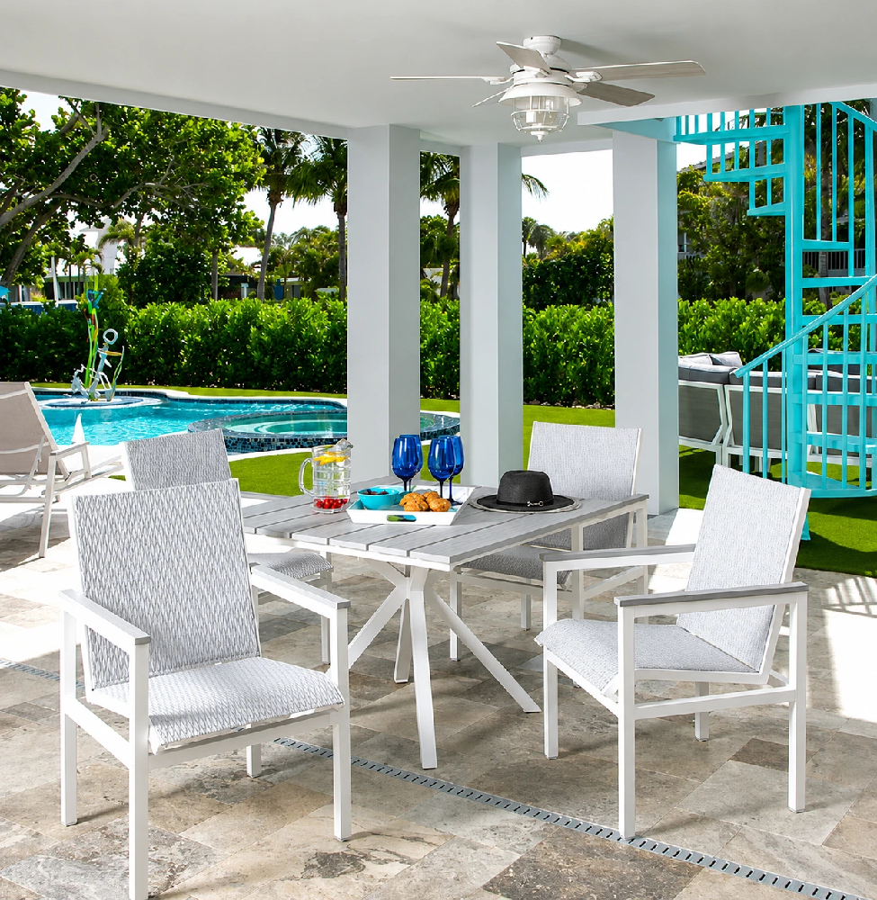 Modern Kingston commercial outdoor dining set with square table beside a luxury swimming pool.